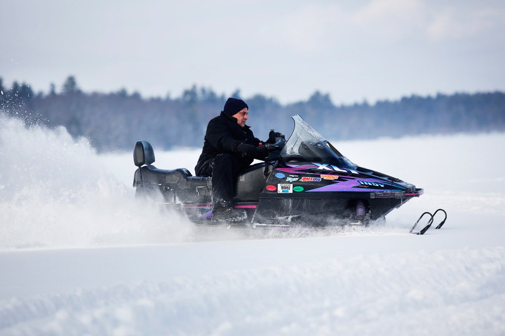 Buddy Keenan of Somerville, Mass., rides a snowmobile Friday at Lower Bay on Sebago Lake. Maine game wardens are warning about "very hazardous" ice conditions created by recent warm weather.