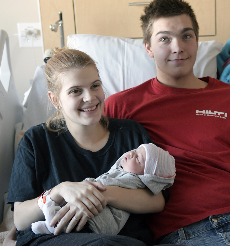 Keira Washburn holds her newborn son, Trenton Salley Jr., sitting beside his father, Trenton Salley, on Monday at MaineGeneral Medical Center in Augusta. The child is the first born in 2018 at the hospital.