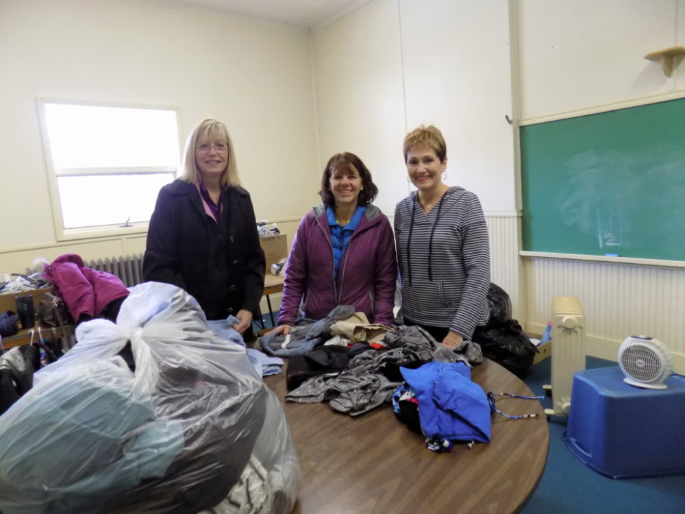 The Free Store, housed on the third floor of the St. Rose of Lima Parish Hall in Jay, is overseen by, from left, Julie Taylor, Tammy Deering and Nancy Anctil.