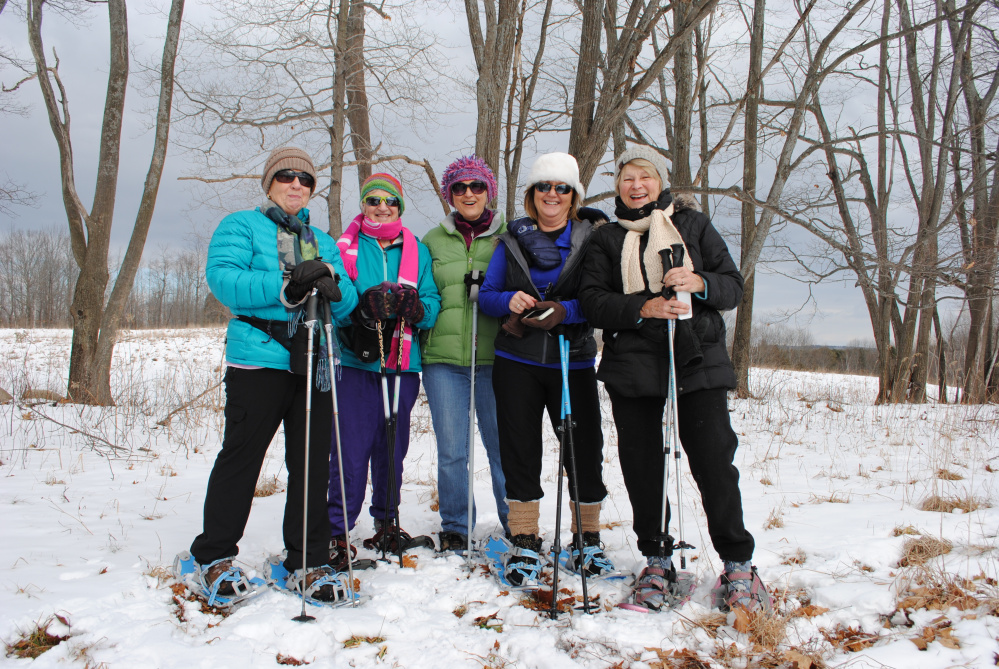 A group of women take a break from snowshoeing at Viles Arboretum in Augusta.