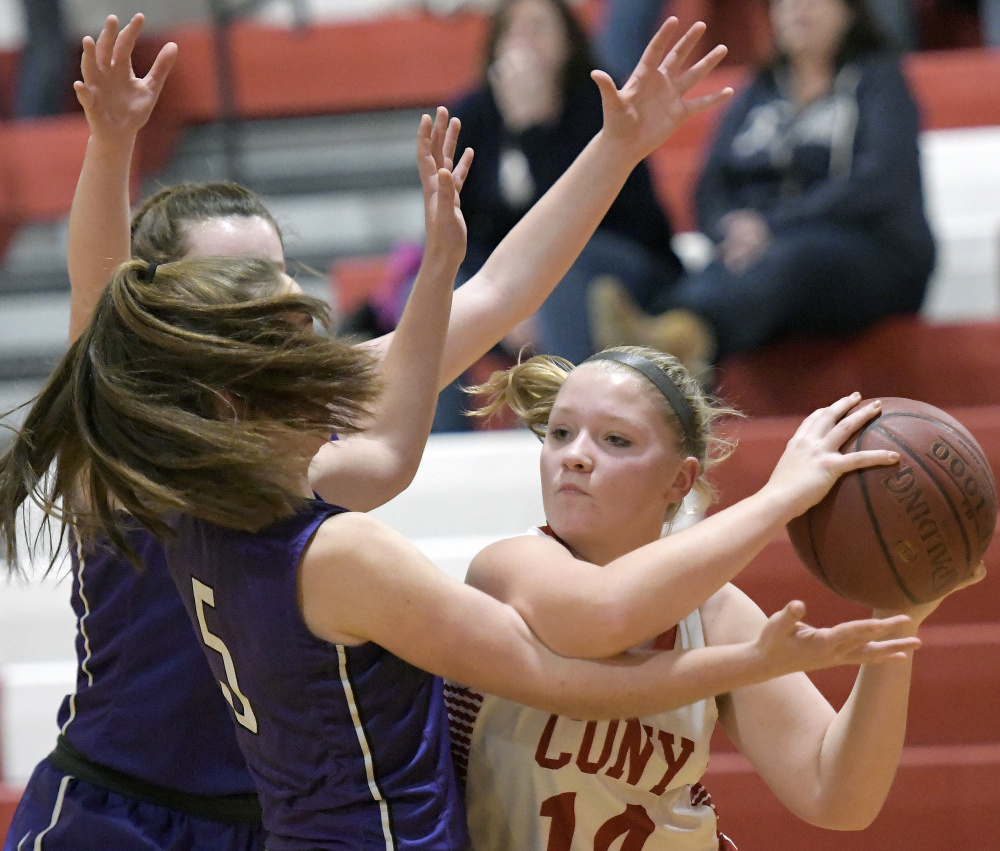 Cony junior Brooklyn Belanger looks for an opening as Waterville defenders converge during a Kennebec Valley Athletic Conference game Tuesday in Augusta.