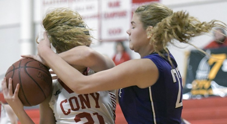 Cony junior Peyton Miller, left, is defended by Waterville's Maddie Martinduring a Kennebec Valley Athletic Conference game Tuesday in Augusta.