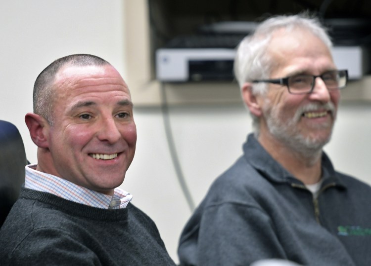 Marc Rines, left, smiles Wednesday after being inaugurated as a Gardiner City Councilor. The son of former mayor Brian Rines and Kennebec County Commisioner Nancy Rines, ran for the seat being vacated by Phil Hart, right, who is stepping down after several decades of service to the community. The swearing in ceremony was held in council chambers in Gardiner.