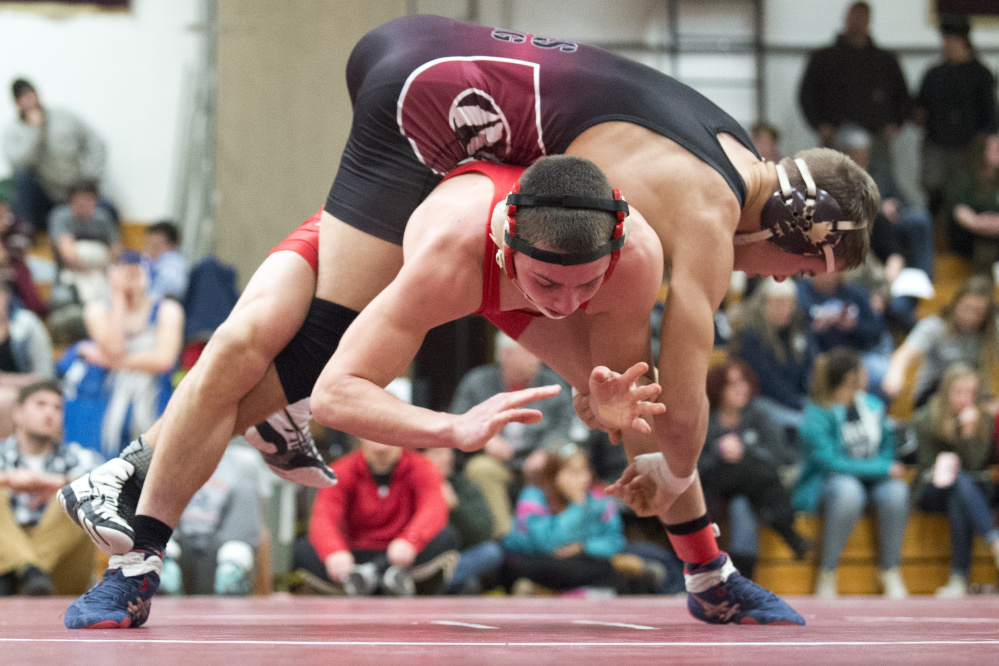 Nokomis High School's David Wilson rides the back of Dexter High School's Tyler Bean in the 160 pound weight class semifinals of the Warrior Clash on Saturday at Nokomis High School in Newport.