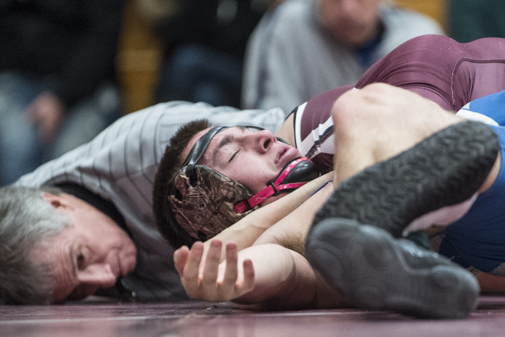 Foxroft Academy's RJ Nelson pins Madison Area Memorial High School's Josh Savage for his 150th high school win in the semifinals of the Warrior Clash on Saturday at Nokomis High School in Newport.