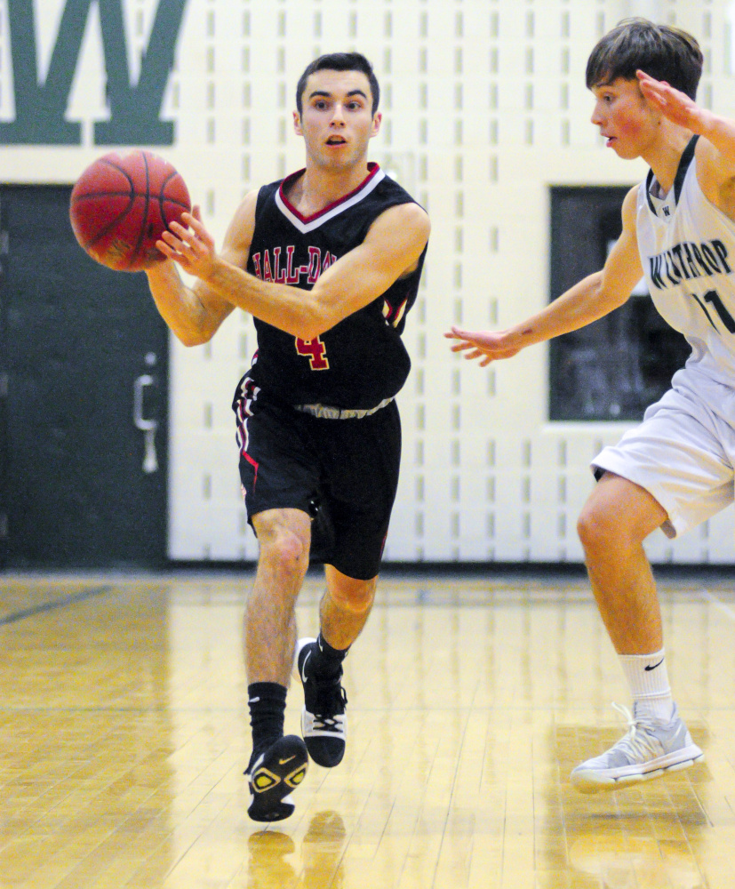 Hall-Dale's Tyler Nadeau, left, looks for a teammate to pass to as Winthrop's Beau Brooks defends during a game Saturday in Winthrop.