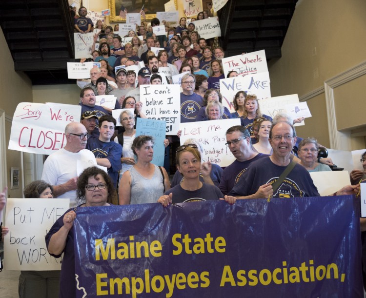 State employees pack the stairs July 3 in the State House Hall of Flags as they worked to keep pressure on lawmakers and Gov. Paul LePage to get a budget approved and end a government shutdown.