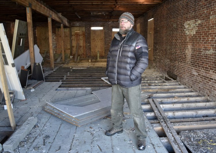 Jason Cooke, standing on Wednesday inside his Water Street property in Skowhegan, has been awarded $20,000 in tax-increment financing funds to help renovate two vacant storefronts in the building at 151 Water St.
