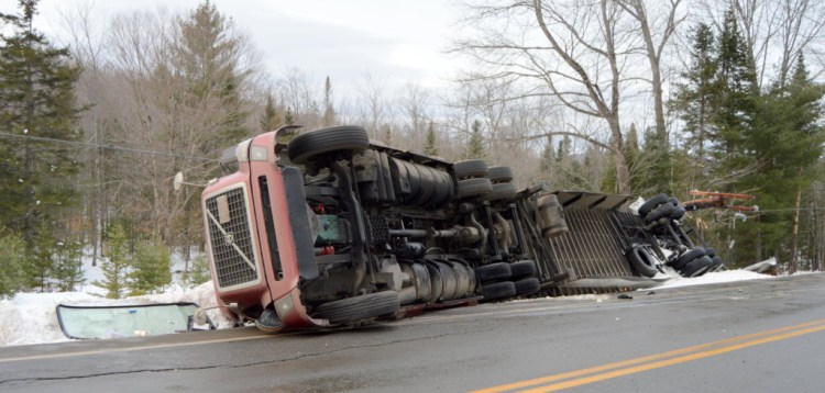 A Utah truck driver was uninjured Thursday afternoon when his tractor-trailer went off the road and rolled over on Route 27 in New Vineyard.