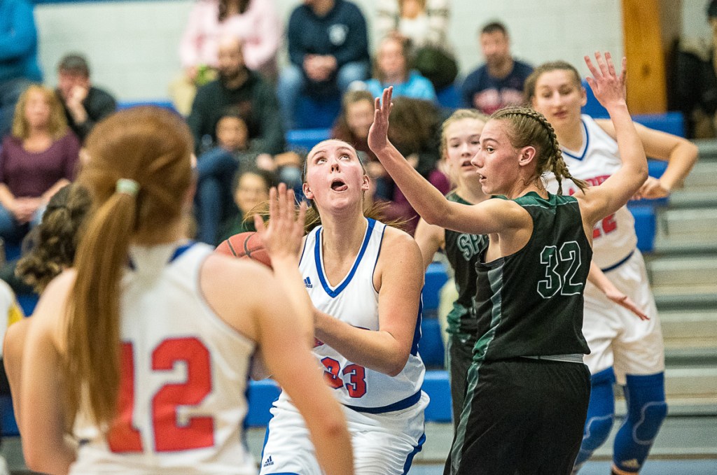 Sun Journal photo by Andree Kehn 
 Oak Hill's Abigail Nadeau concentrates on getting a shot past Spruce Mountain's Calley Baker during a game Thursday night in Wales.