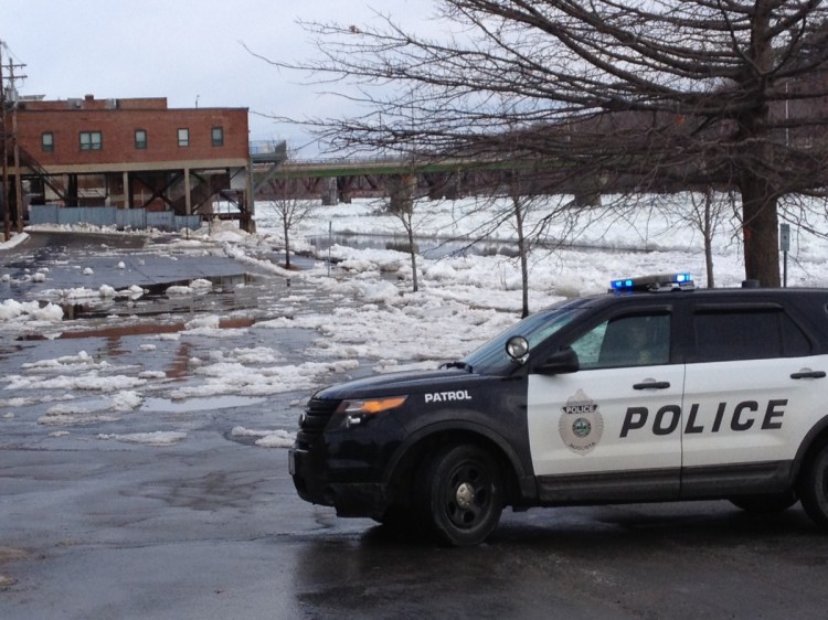 Augusta police and public works crews block off Front Street on Feb. 17, 2016, in Augusta because of Kennebec River flooding.