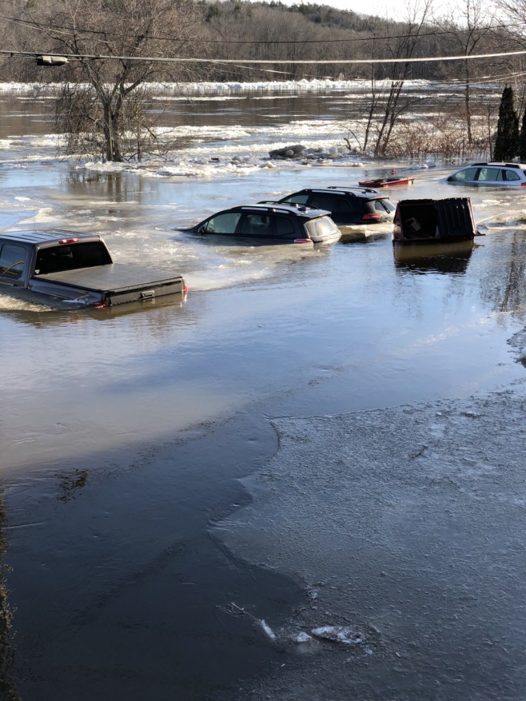 Cars submerged by flooding Kennebec River on Sunday in Hallowell.