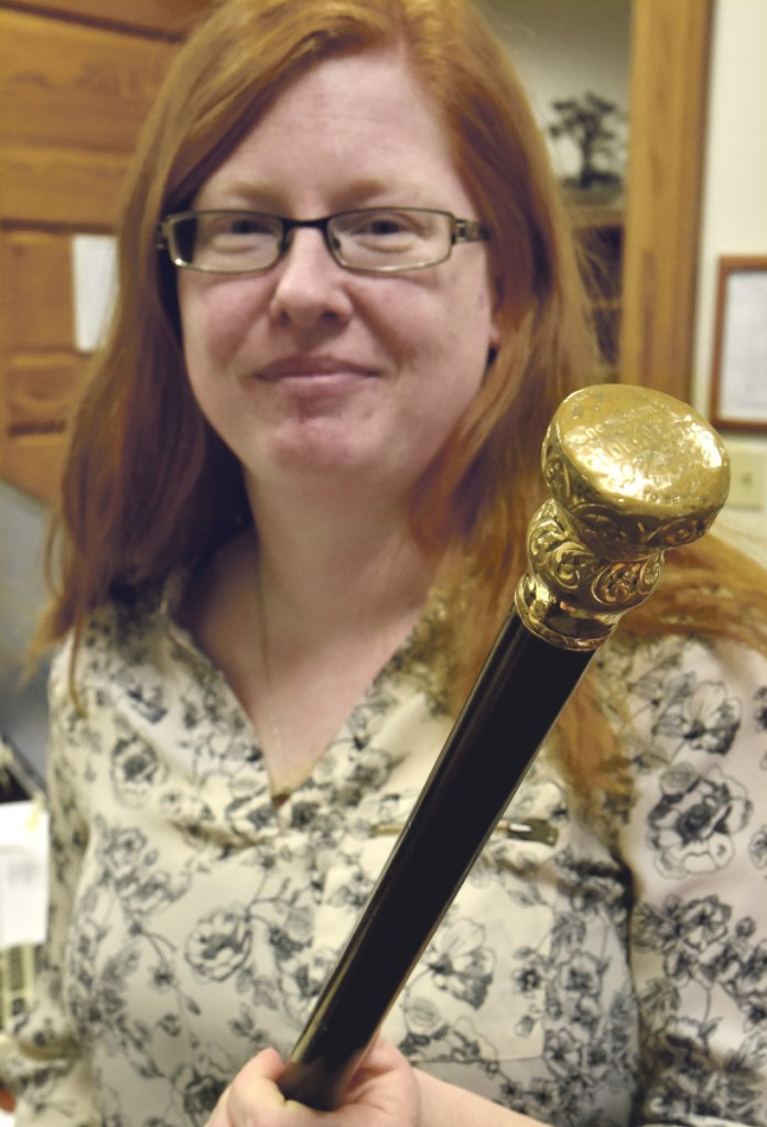 Skowhegan Town Manager Christine Almand holds the gold-topped ebony Boston Post Cane at the town office in Skowhegan on Monday. The last time the town's eldest citizen received the cane was in 1999, according to research done by Town Clerk Gail Pelotte. Efforts are underway to restore the New England tradition.