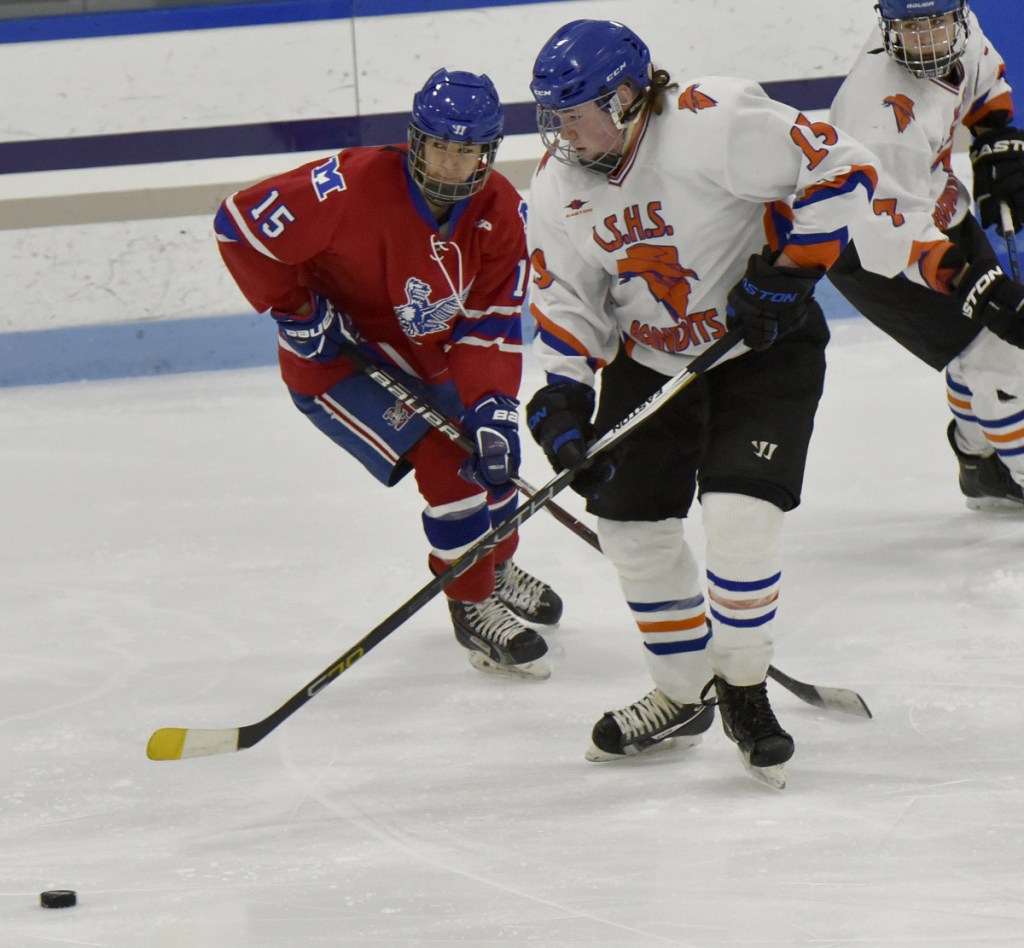 Messalonskee's Reilly Benecke, left, and Lawrence/Skowhegan/MCI's Jacob Suttie play Monday at Alfond Rink in Waterville.