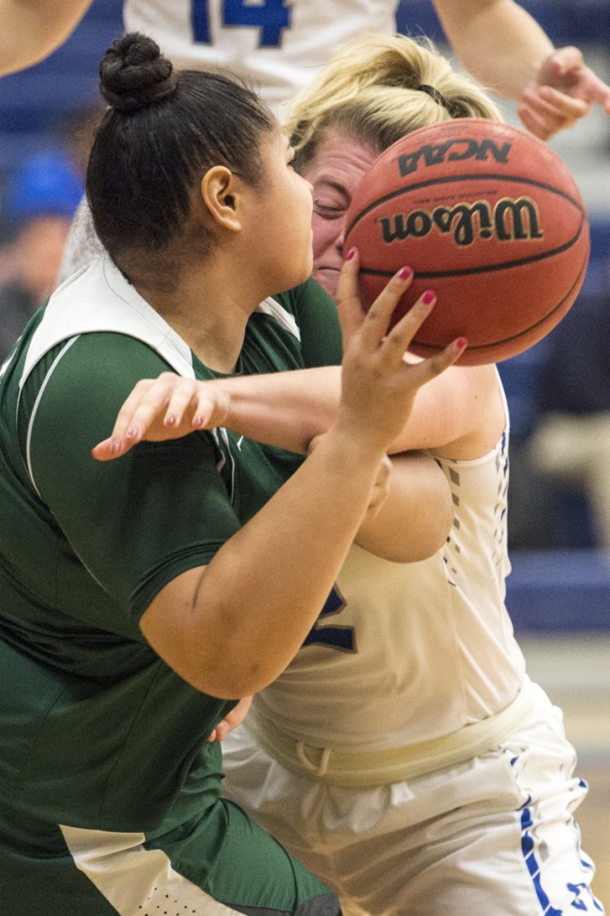Pine Manor College's Aleah Lauti, left, battles for the loose ball with Colby College's Sarah Hancock on Tuesday at Colby College in Waterville.