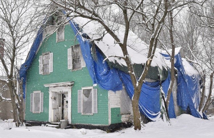 Charles McIntyre's house on Main Street in Clinton, seen Wednesday, has been in what the town calls a state of disrepair for decades and will be the subject of a meeting by the town to determine a course of action.