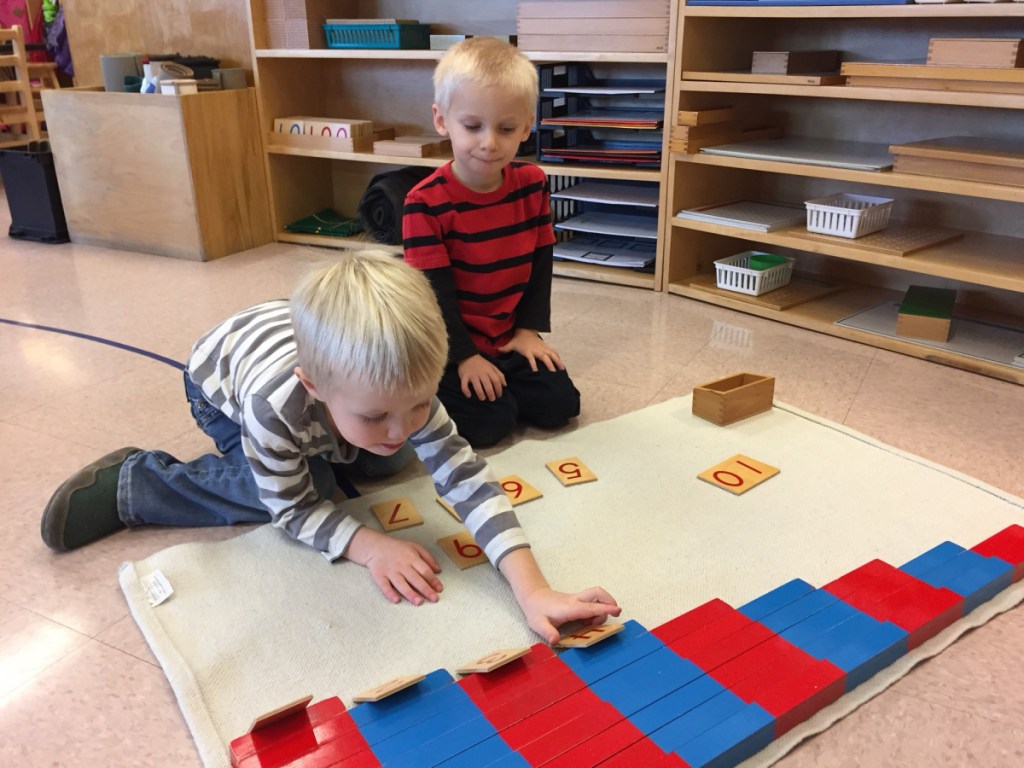 Kennebec Montessori School students James Browne, left, works on a math skill as Robert Krickus waits for his turn.