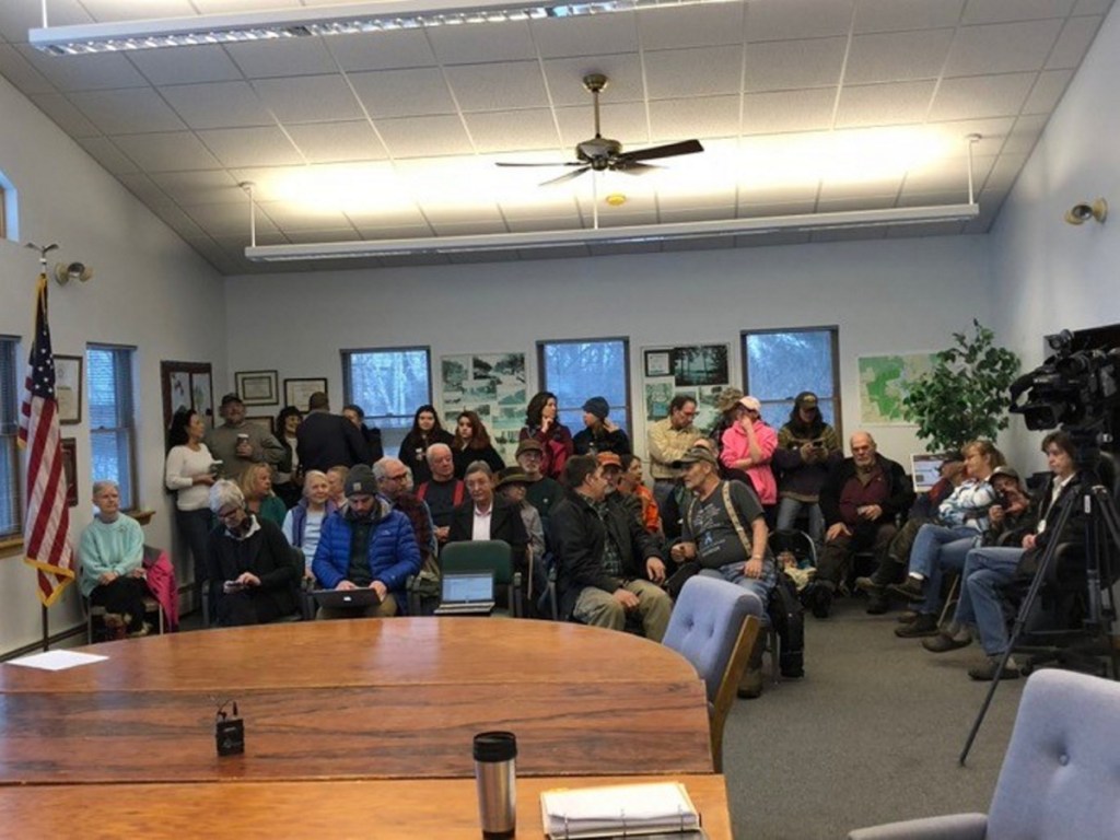 A standing-room-only crowd waits Tuesday morning at the Jackman Town Office as selectmen meet in executive session to discuss the employment of Town Manager Tom Kawczynski following widespread uproar over his white separatist views.
