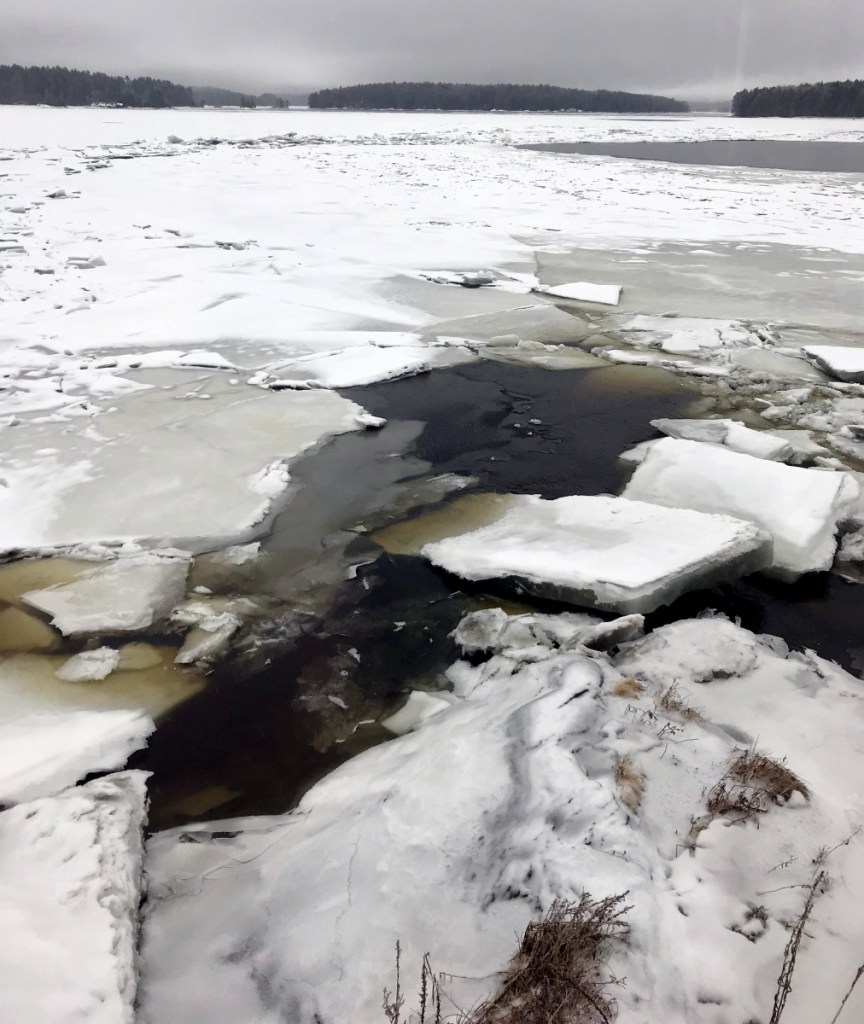 Ice chunks cling to the Kennebec River shore on Tuesday at Chop Point School in Woolwich, where U.S. Coast Guard vessels are scheduled to arrive Wednesday as part of an early ice-breaking operation to ward off flooding near Augusta.