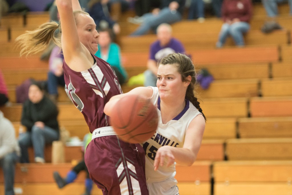 Waterville's Lindsay Given (15) looks to pass to an open teammate while Maine Central Institute's Sydney Morton defends her Wednesday night at Waterville Senior High School. 