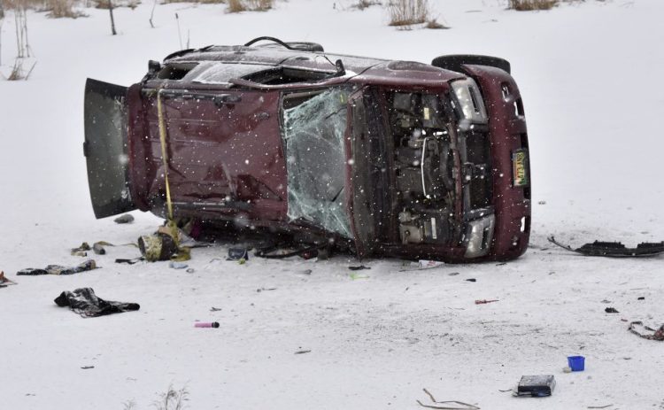 An overturned truck lies on the ice of a small pond early Monday along U.S. Route 2 in Skowhegan.