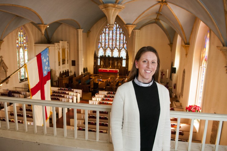 The Rev. Kerry Mansir poses inside Christ Church Episcopal in Gardiner. She had been a deacon and was ordained as a priest Jan. 20.