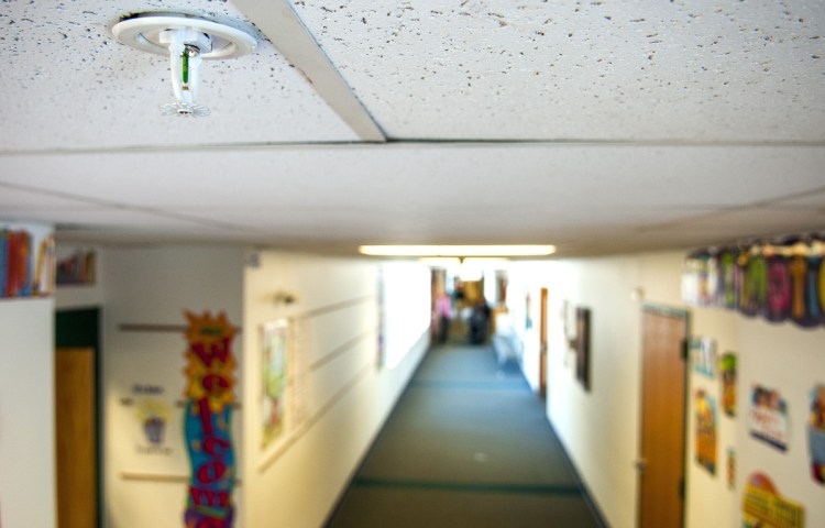 A sprinkler head is seen in a hallway of the Winthrop Grade School.
