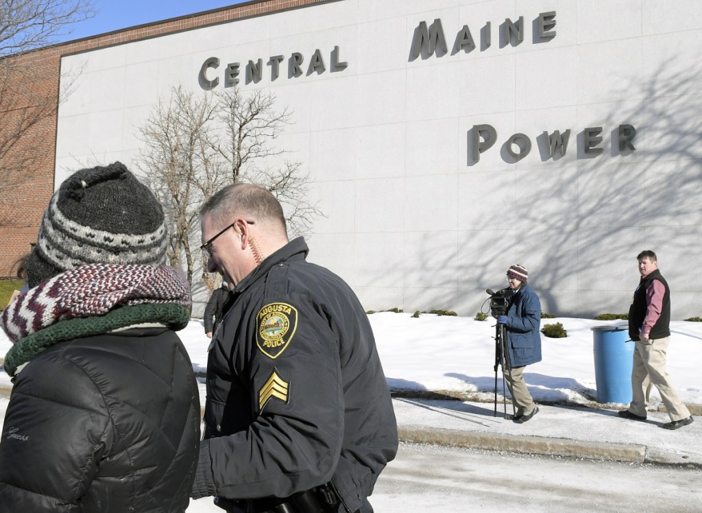 Augusta Police Dept. Sgt. Danny Boivin arrests a protester at Central Maine Power in Augusta on Monday.