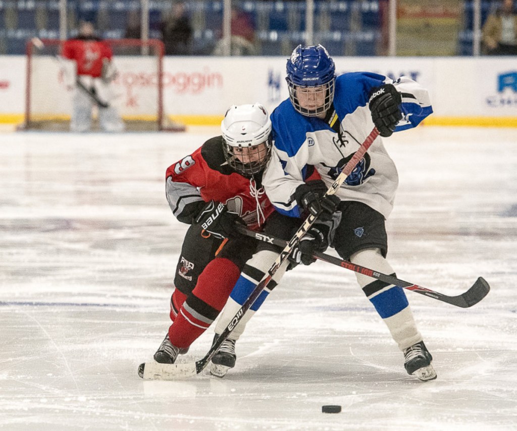 Lewiston/Oak Hill/Monmouth forward Anna Dodge looks to fend off Edward Little/Poland/Leavitt's Taylor Caillier during a Dec. 20, 2017 game at the Androscoggin Bank Colisee in Lewiston.
