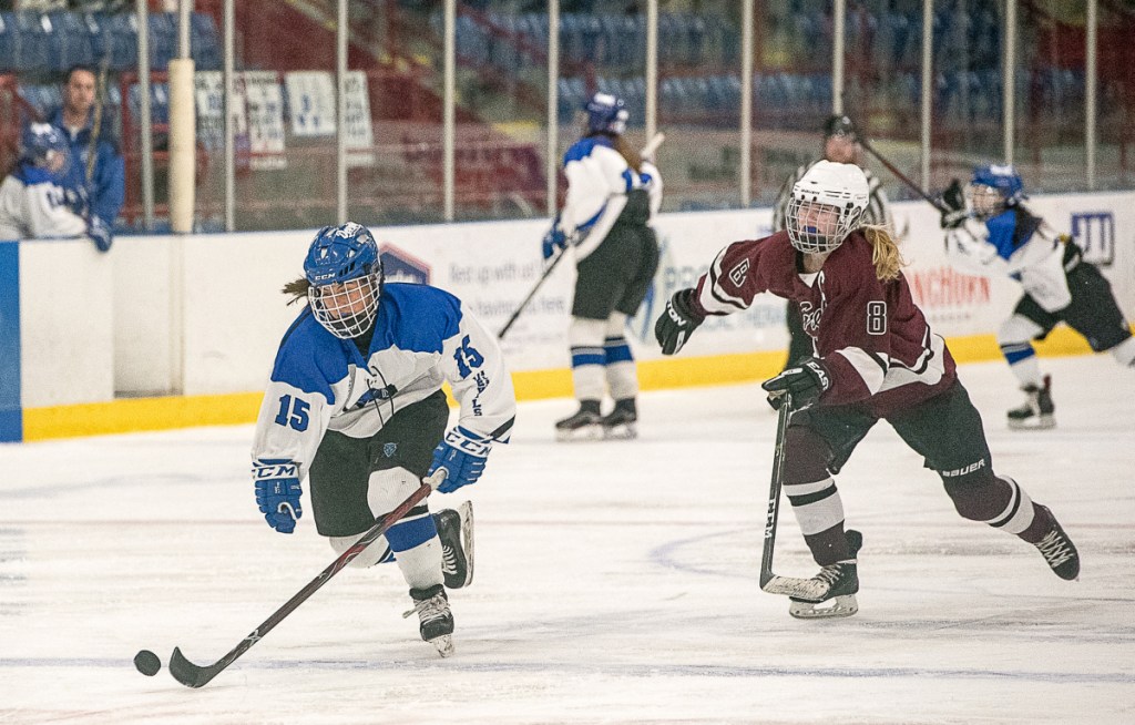 Lewiston/Monmouth/Oak Hill's Sara Robert is chased by Greely/Gray-New Gloucester's Molly Horton during a game at the Androscoggin Bank Colisee in Lewiston last Friday night.