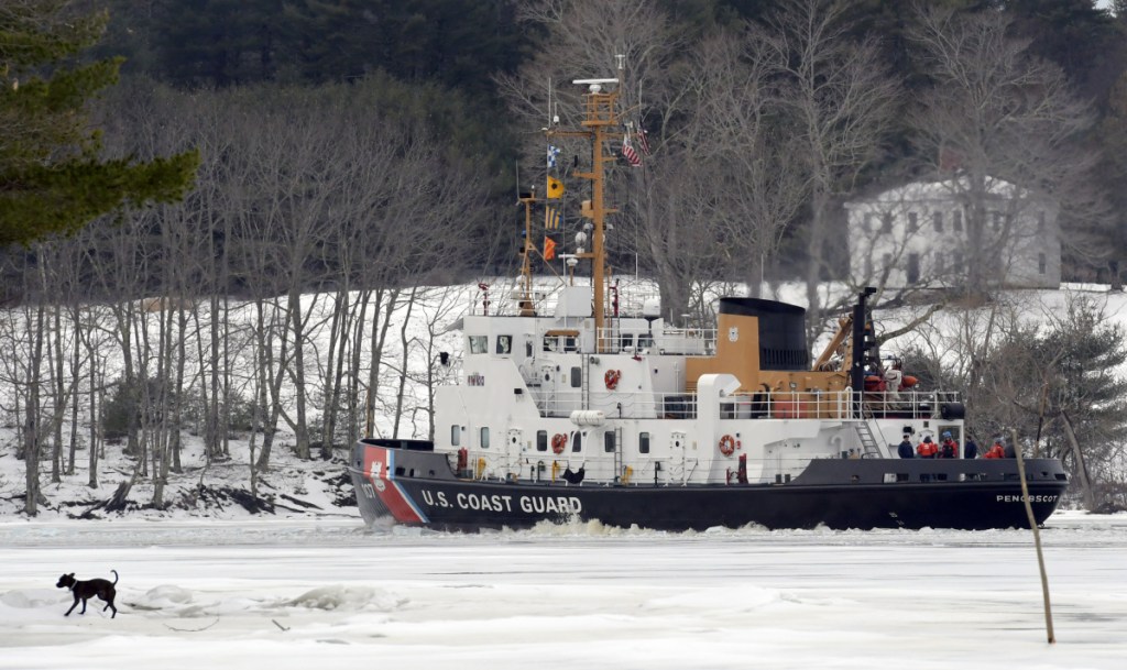 The USCGC Penobscot Bay on Sunday breaks a path through the Kennebec River between Richmond and Dresden.