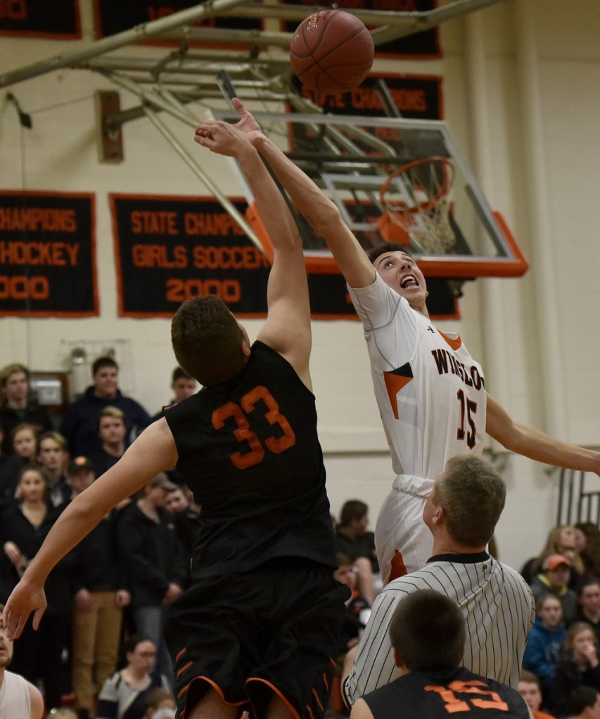 Skowhegan's Kiel LaChappelle and Winslow's Jack Morneault go up for jump ball during a game Tuesday in Winslow.