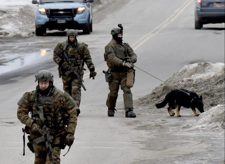 Heavily armed state police troopers and a dog walk along West Street in Fairfield on Tuesday toward a residence near the Montcalm Street intersection, where police were engaged in a standoff with Kenneth J. Ruggiero. Ruggiero was arrested without incident and charged with domestic violence assault, domestic violence terrorizing and refusing to submit to arrest.