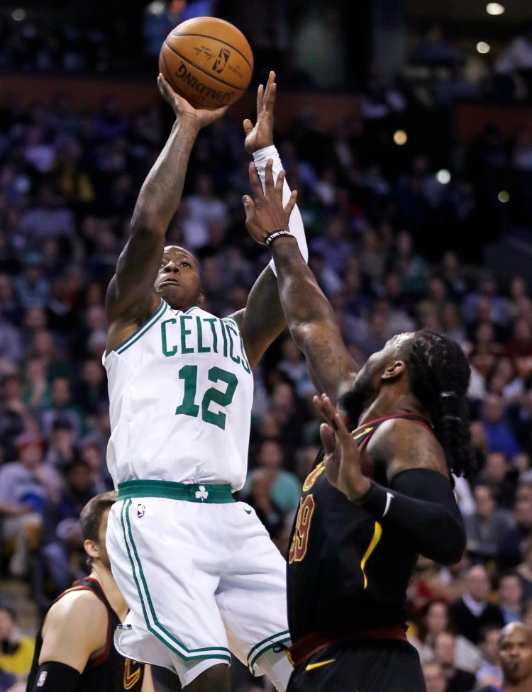 Boston's Terry Rozier  shoots over Cleveland's Jae Crowder in the fourth quarter Wednesday night in Boston. Rozier scored 20 points in Boston's 102-88m win.