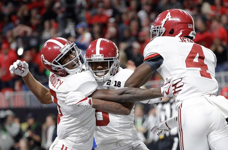 Alabama wide receiver DeVonta Smith (6) celebrates his touchdown during overtime of the NCAA college football playoff championship game against Georgia on Monday in Atlanta. Alabama won 26-23 in overtime.