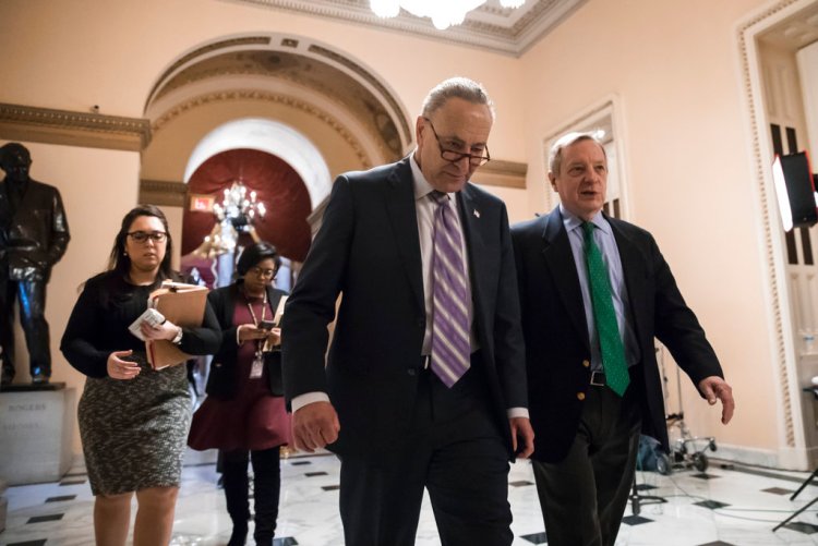 Senate Minority Leader Chuck Schumer, D-N.Y., left, walks with Sen. Dick Durbin, D-Ill., the minority whip, as lawmakers continue negotiating on a deal that would include a fix for the Deferred Action for Childhood Arrivals (DACA) program, at the Capitol in Washington, Thursday.
