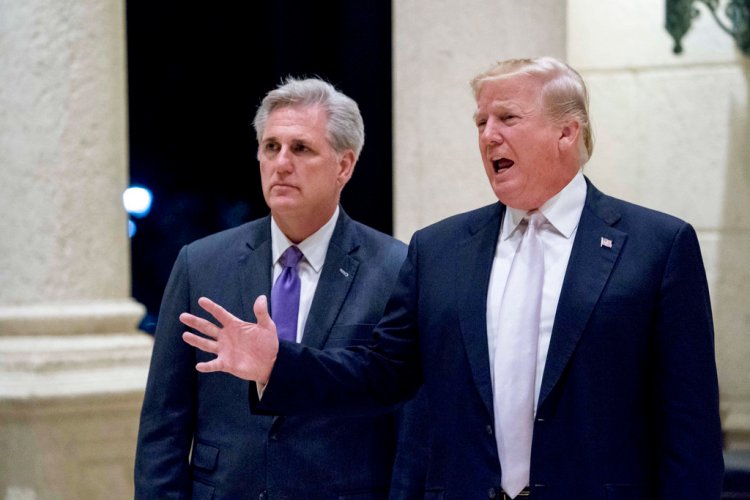 President Donald Trump, right, accompanied by House Majority Leader Kevin McCarthy, R-Calif., speaks to members of the media as they arrive for a dinner at Trump International Golf Club in West Palm Beach, Fla., Sunday.