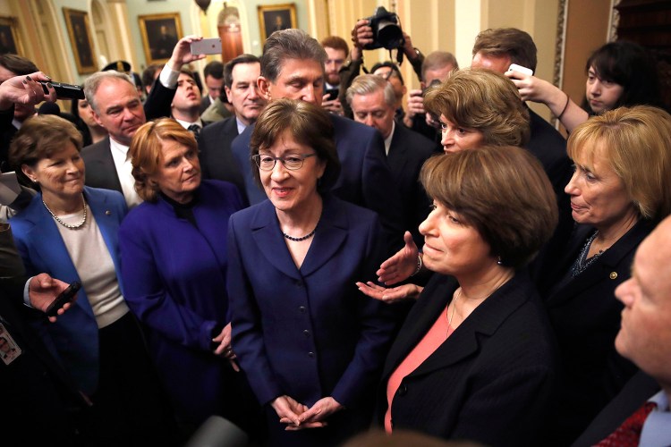 Following a procedural vote aimed at reopening the government, Sen. Susan Collins, R-Maine, center, was praised by her fellow lawmakers for leading the bipartisan effort at the Capitol in Washington on Monday. From left are, Sen. Jeanne Shaheen, D-N.H., Sen. Heidi Heitkamp, D-N.D., Collins, behind Collins is Sen. Joe Manchin, D-W.Va., Sen. Lisa Murkowski, R-Alaska, Sen. Amy Klobuchar, D-Minn., and Sen. Maggie Hassan, D-N.H. 