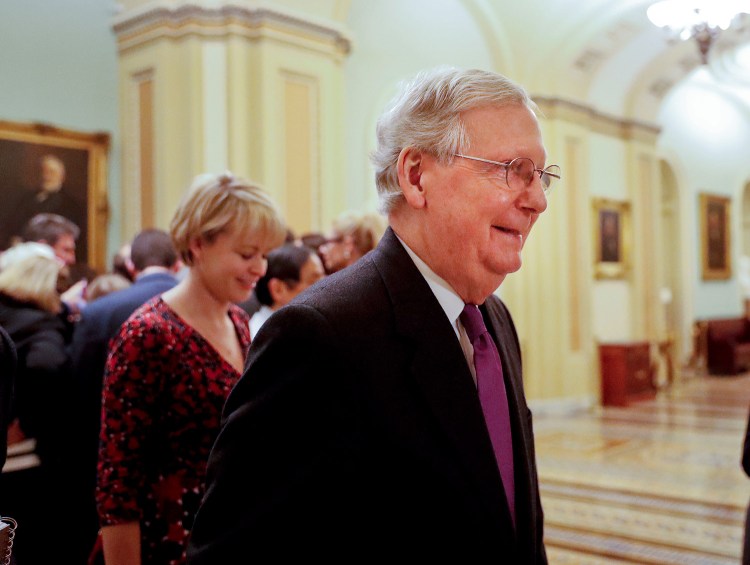 Senate Majority Leader Mitch McConnell of Kentucky walks back to his office on Capitol Hill in Washington on Monday. The Senate voted to approve a stopgap funding measure to keep the government open for a few more weeks.