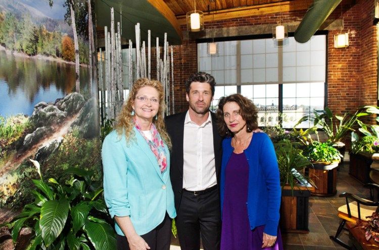 Patrick Dempsey poses with his sisters Mary, left, and Alicia in Amanda's Garden, a room at the Dempsey Center in Lewiston that was dedicated to their mother in September 2014. Mary Dempsey is leaving her role at the center.