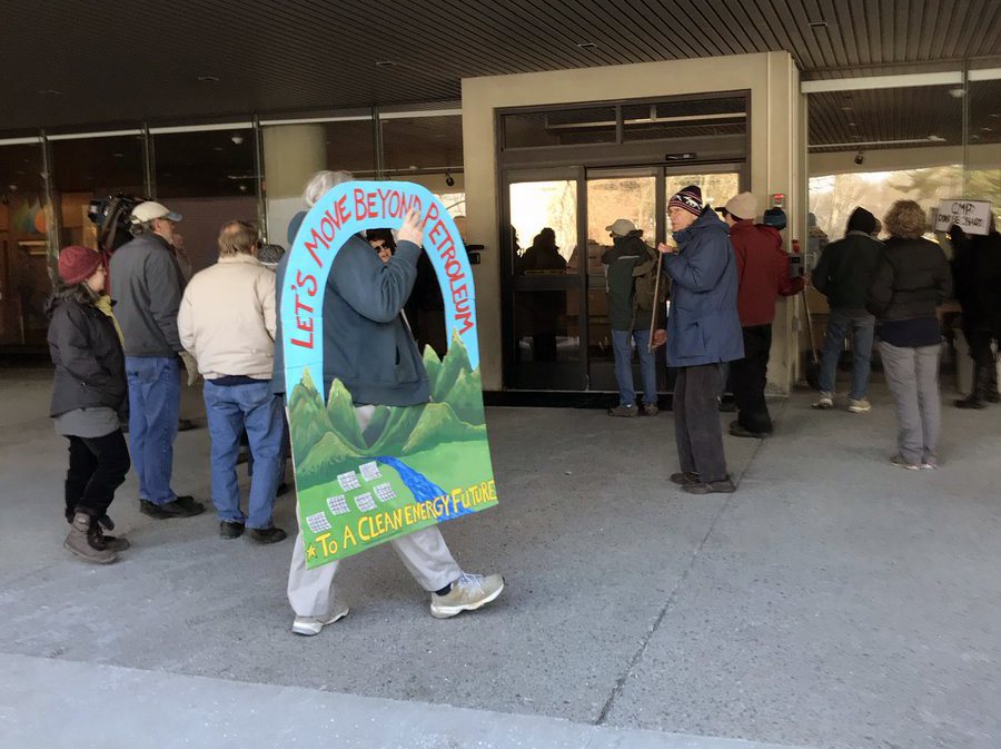 Protesters at the doors of Central Maine Power after being kept out of the lobby Monday. 