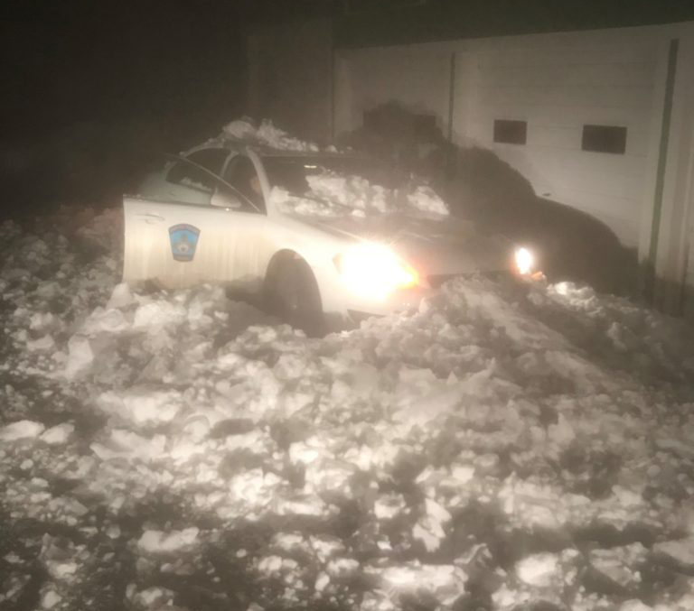 A Capitol Police cruiser is seen Thursday after snow and ice slid off the roof of a state-owned building and crushed the vehicle.