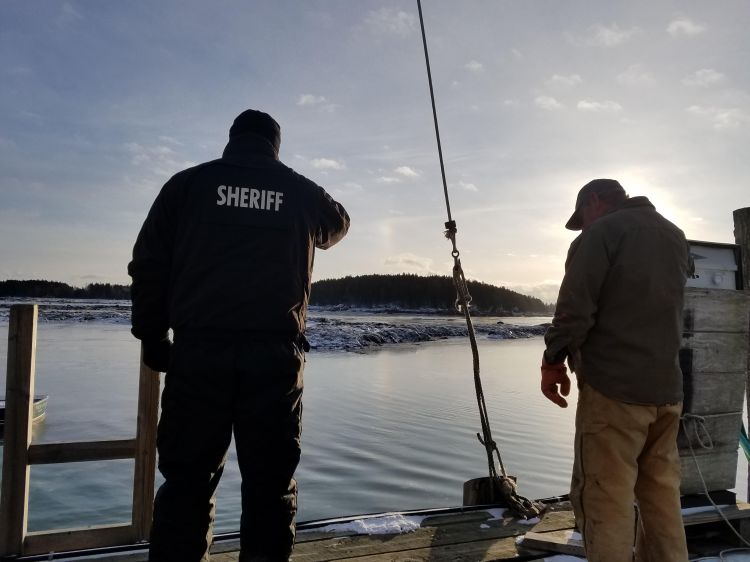 Knox County Sheriff's Office Chief Deputy Tim Carroll, left, looks out over the cove where search efforts continued Saturday for Paul Benner. His body was recovered Monday.