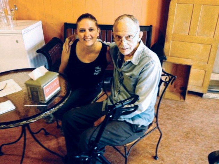 Jorgensen's Cafe owner Theresa Dunn poses with Vern Miller, a well-known figure in downtown Waterville who had his own booth in the cafe, where he spent all day counseling people and giving advice. Miller died Sunday at the age of 92.