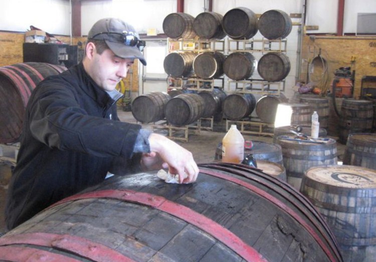 Matt Albrecht, owner and founder of River Drive Cooperage-Millwork in Buxton, prepares a barrel he imported from Hungary for shipment to Michigan. "Our goal is to push the limits on beer barrel aging," he said.