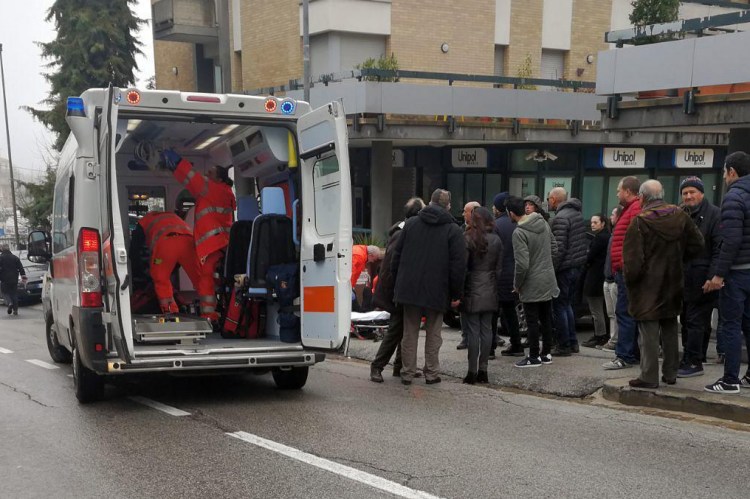 Paramedics attend a wounded man after a shooting broke out in Macerata, Italy on Saturday. Italian police arrested a lone gunman in a series of drive-by shootings targeting foreigners Saturday morning that paralyzed a small central Italian city still reeling from the gruesome murder of a young Italian woman allegedly at the hands of a Nigerian immigrant.