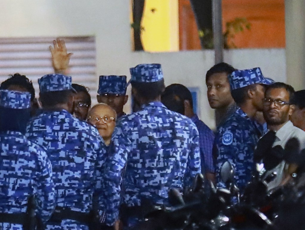 Police officers arrest former president and opposition leader Maumoon Abdul Gayoom, center, Tuesday after the government declared a state of emergency in Male, Maldives.