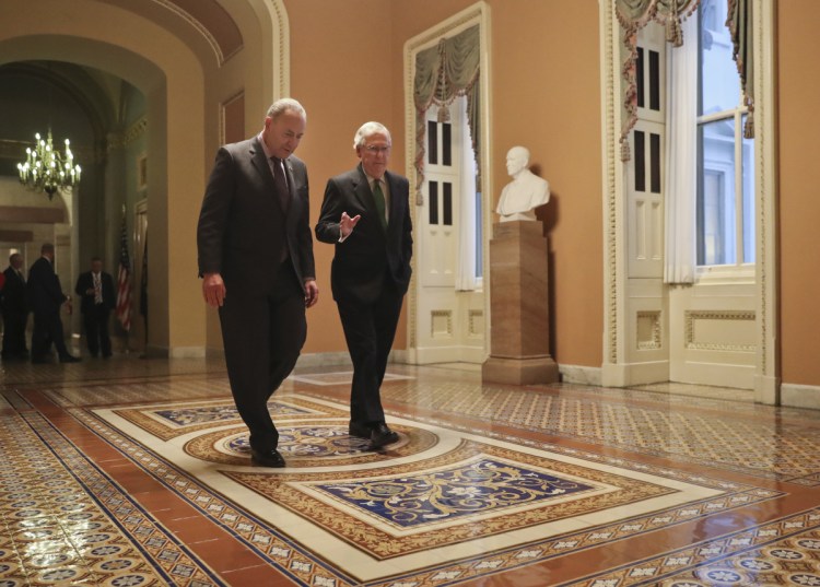 Senate Majority Leader Mitch McConnell, R-Kentucky, and Senate Minority Leader Chuck Schumer, D-New York, left, walk to the chamber after collaborating on an agreement in the Senate on a two-year, almost $400 billion budget deal that would provide Pentagon and domestic programs with huge spending increases, at the Capitol in Washington on Wednesday.