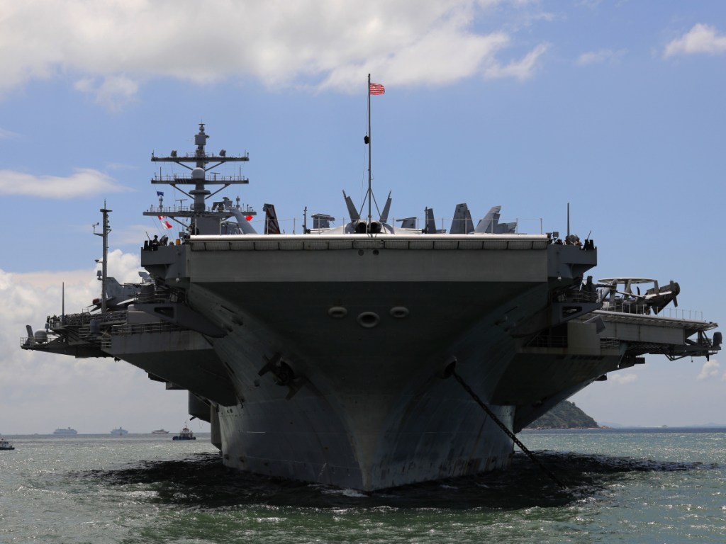 The USS Ronald Reagan aircraft carrier arrives in Hong Kong last October. The $700 billion Pentagon budget that President Trump signed Friday means the military can foot the bill for thousands more troops, more training, more ships and a lot else.