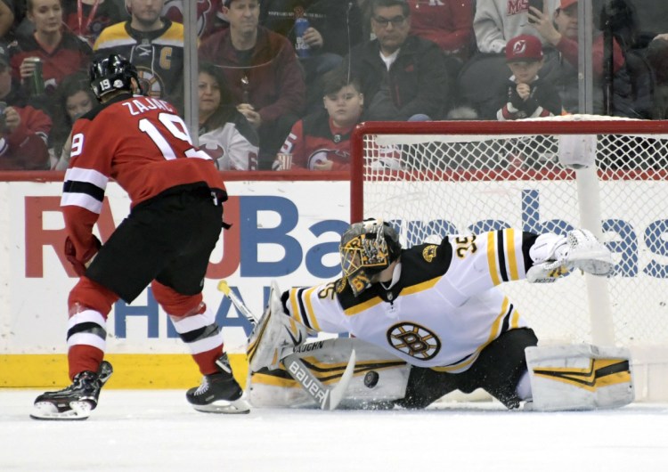 Goaltender Anton Khudobin of the Boston Bruins makes a save on a penalty shot by Travis Zajac of the New Jersey Devils in the first period of the Bruins' 5-3 victory Sunday night.